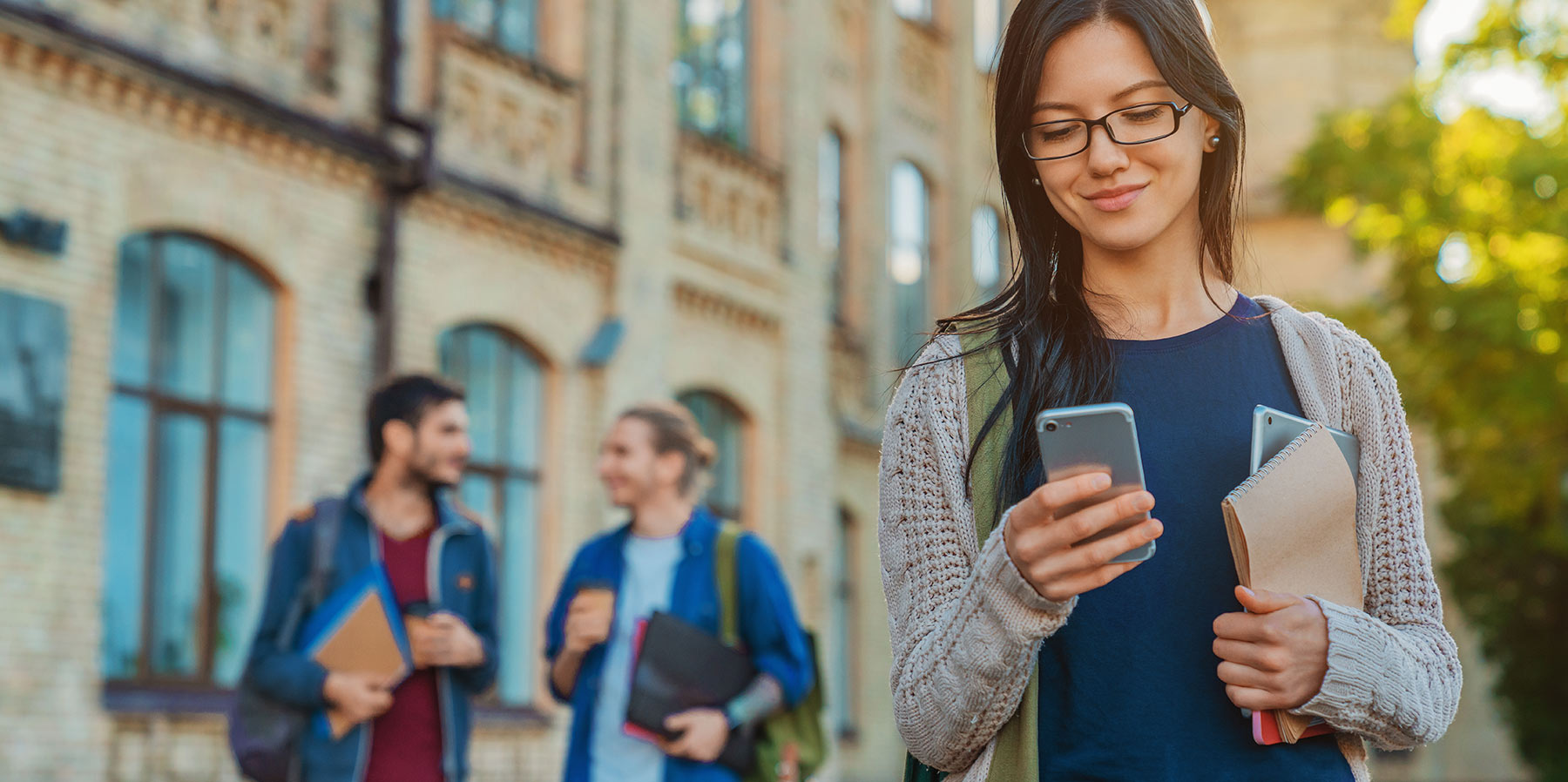 Photo of a college student using mobile device to find an NWA business online