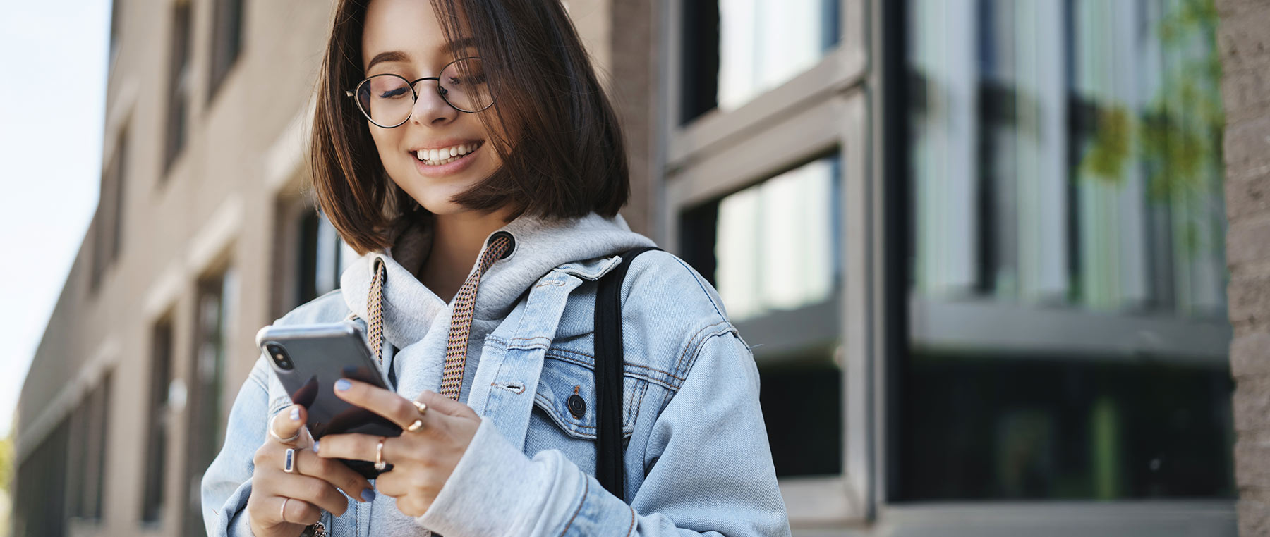 Photo of a woman looking at a website optimized for mobile viewing.